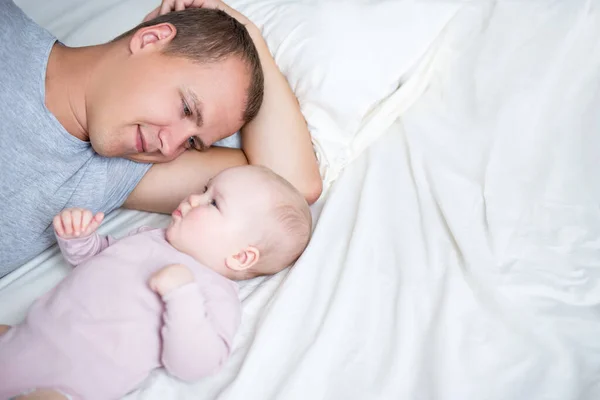 Close Young Father Lying Baby Girl Bed Copy Space White — Stock Photo, Image