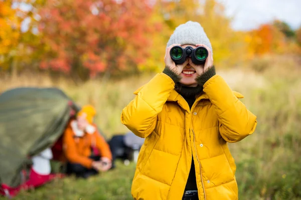 远足及徒步旅行的概念 秋林中带双筒望远镜的年轻貌美女子 — 图库照片