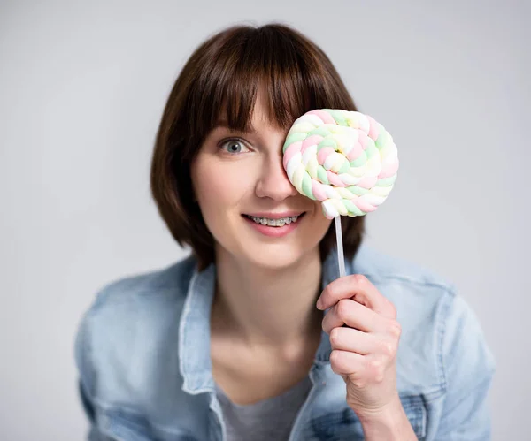 Portrait Funny Young Woman Teenage Girl Covering Face Lollipop Gray — Stock Photo, Image