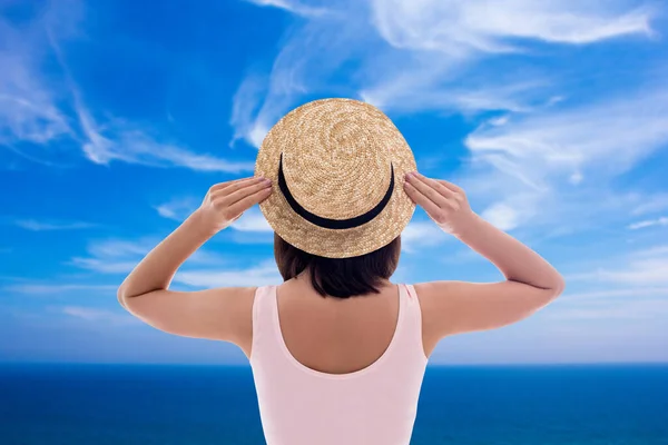 暑假和旅行理念 蓝色阴天背景下身穿泳衣 戴草帽的年轻女性的回顾 — 图库照片