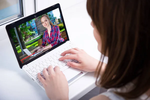 ビデオブログのコンセプト ホームでラップトップでビジネスビデオを見て若い女性のバックビュー — ストック写真
