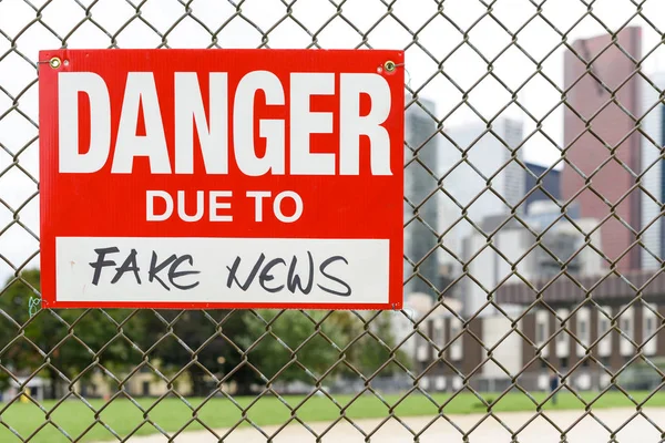 Подпишите Опасные Бумаги Поддельных Новостей Прикрепленных Заборе Перед Городом — стоковое фото