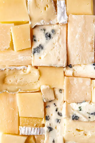 Mosaic from cheese as background — Stock Photo, Image