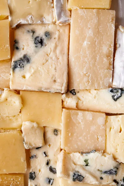 Mosaic from cheese as background — Stock Photo, Image