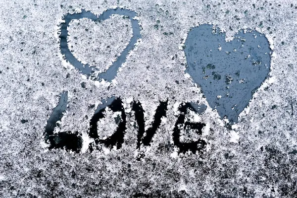 The word love and a hearts on a car window. white background