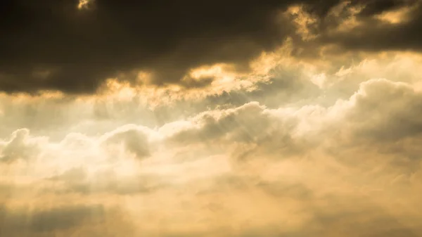 Sun rays through clouds like an dramatic explosion , power nature background.