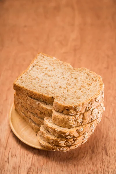 whole wheat bread, bio ingredients, very healthy on wood table