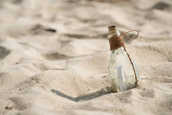 Письмо в стеклянной бутылке на пляже, концепция для связи — стоковое фото
