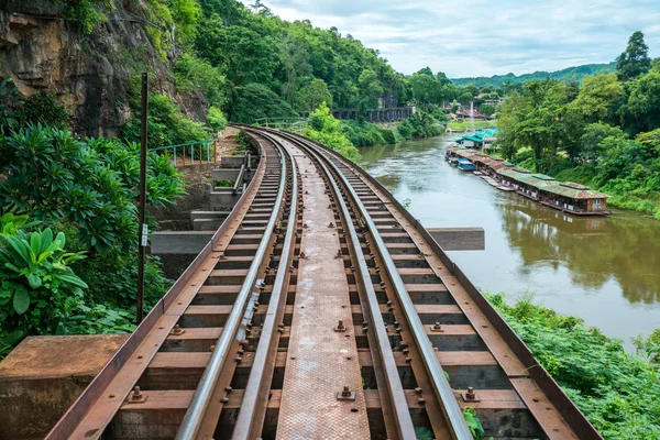 Old railroad tracks on bridge beside cliff rock — Stock Photo, Image