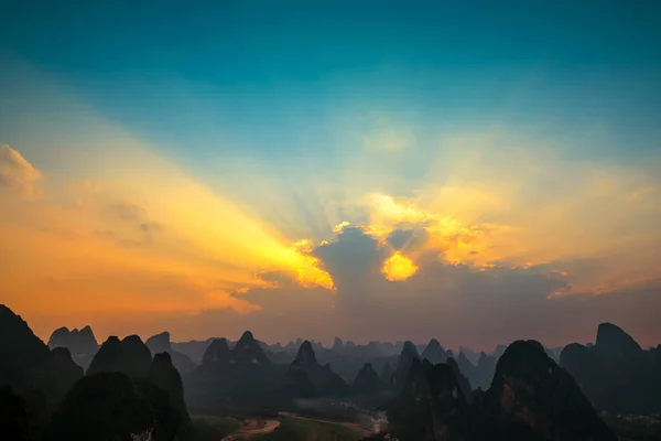 Sun rays through clouds like an dramatic explosion , power nature background. Sky landscape at Guilin, Karst mountains called Laozhai mount, Guangxi Province, China
