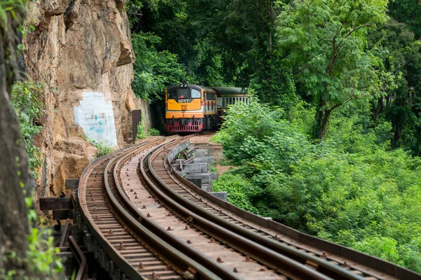 Old railroad tracks on bridge beside cliff rock — Stock Photo, Image