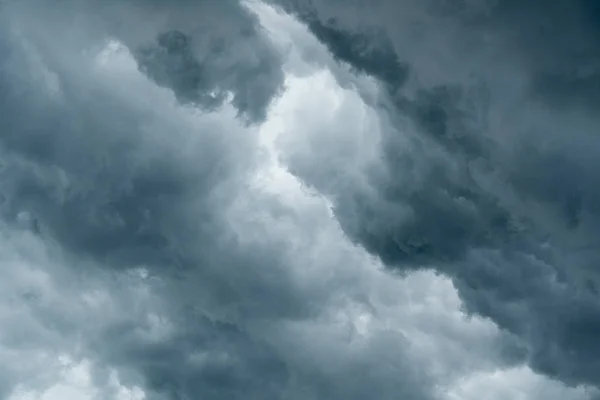 storm cloud background during raining. Dark Clouds. Huge black clouds on dark sky before a thunder-storm.