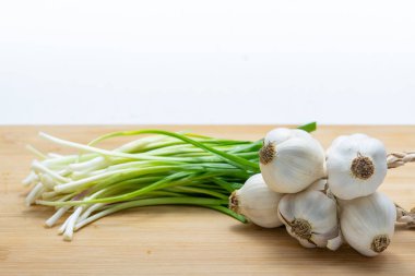 Kesme tahtası üzerinde sarımsak ve yeşil sarımsak Başkanı için önceden 