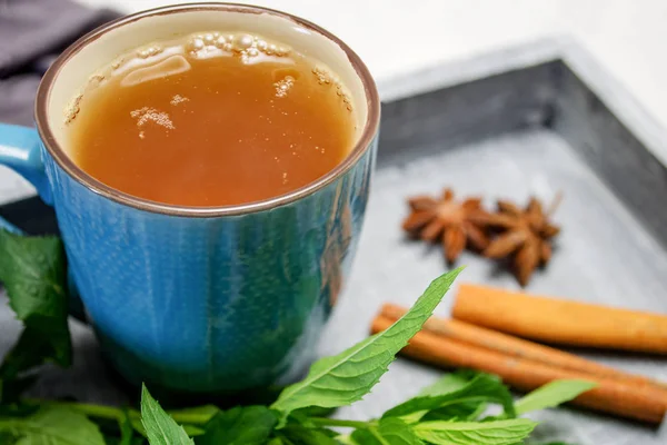 Breakfast. A cup of tea on a tray with a bunch of mint, starlets — Stock Photo, Image