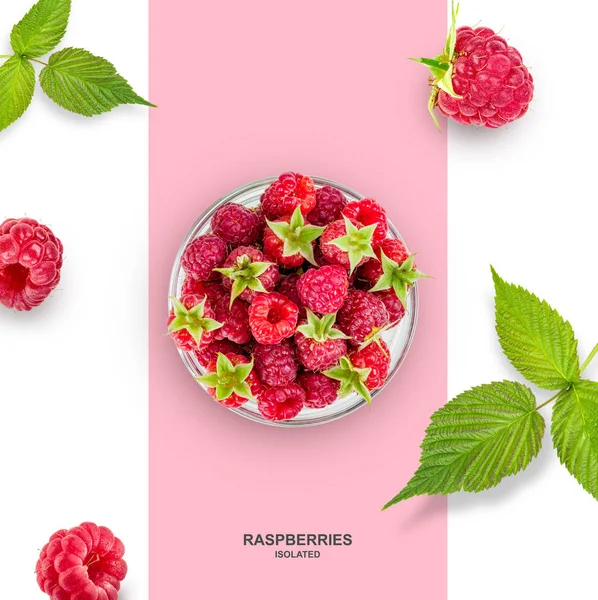 Raspberries in a plate and scattered, with green leaves / Top view — стоковое фото
