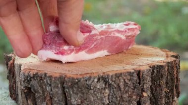 meat chopped with an ax on a log