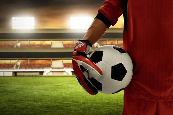 Soccer goalkeeper holding soccer ball