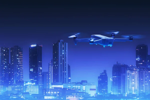 Drone quadcopter flying above city