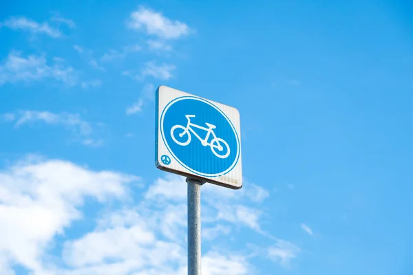 Post sign bike in white background. Summer and cloud in daytime.