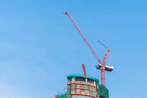 Construction cranes of tall buildings — Stock Photo, Image