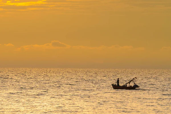 Fishing boat in sunset. Stock Photo