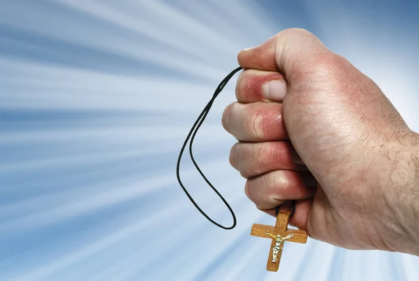 Hand with a wooden cross