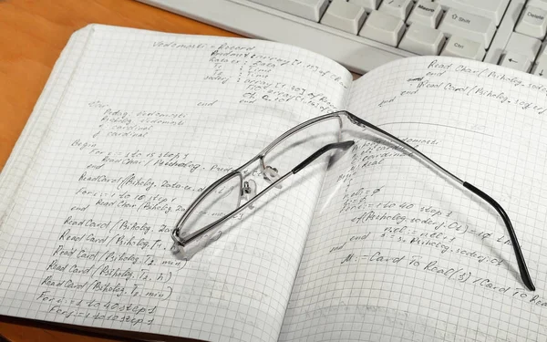 Notebook en bril en toetsenbord — Stockfoto
