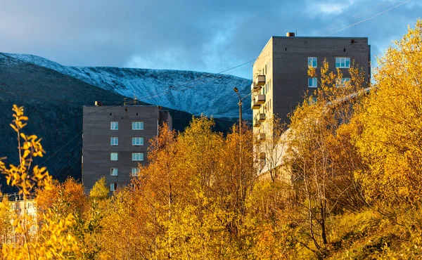 Gold autumn, yellow leafs from window to buildings and mountains, Rusian Nord, Kirovsk
