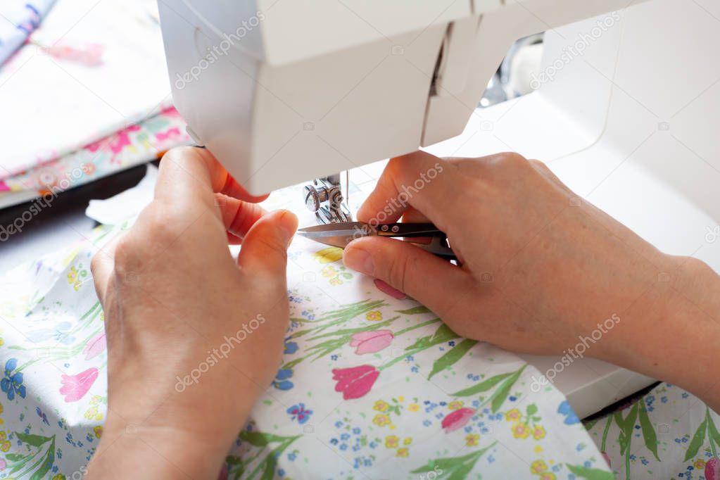 Dressmaker at work, building patterns, hands, modeling, measuring, sewing machine