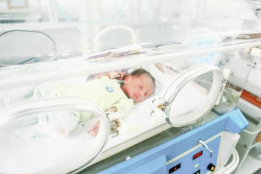 SLIVEN, BULGARIA - January 21, 2012: Newborn baby in hospital. clipart