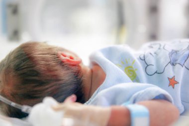SLIVEN, BULGARIA - January 21, 2012: Newborn baby in hospital. clipart