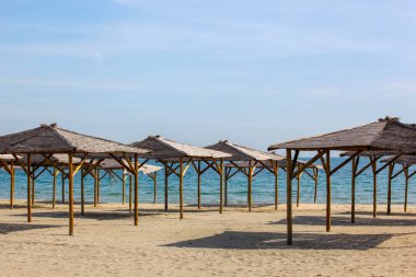 Boş plajda kum şemsiyeler