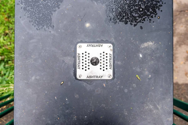 Close up of metal grate with holes on bin for cigarette ends UK — Stock Photo, Image