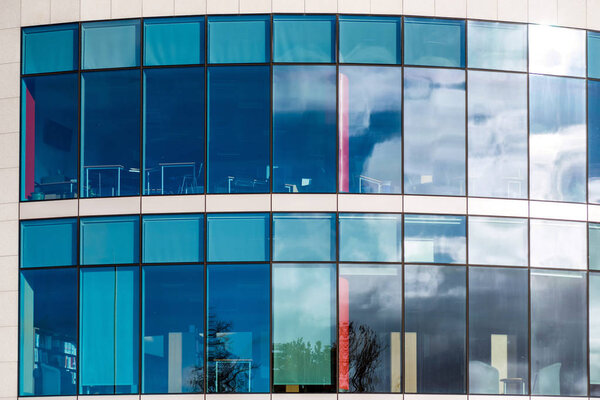 Sunny day view of windows of modern business corporate office building in northampton england uk.