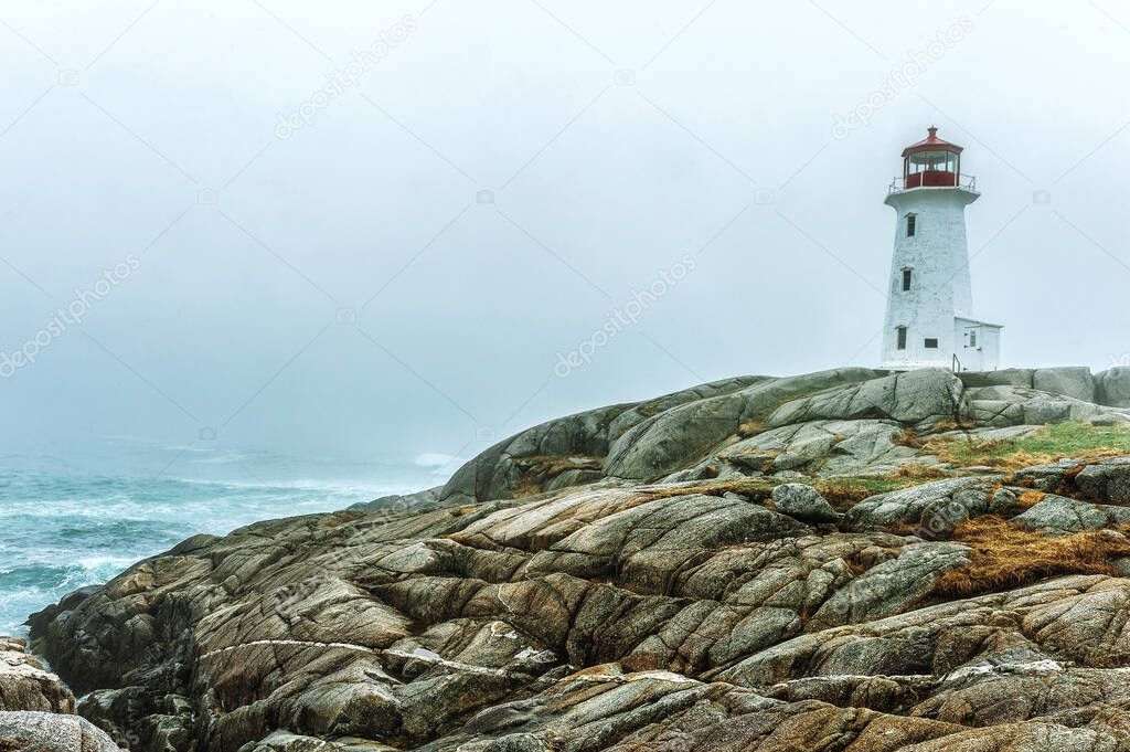 Beautiful lighthouse standing on a rocky coast against the background of the sea