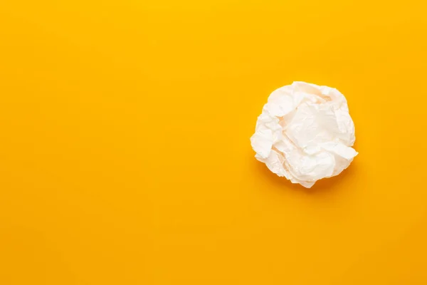 White paper bag on yellow background.