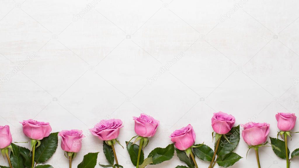 Flowers valentine day composition. Frame made of pink rose on gr
