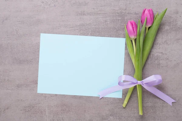 Spring greeting card, pink color tulips on the gray background. — Stock Photo, Image
