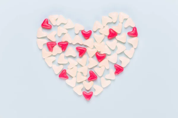 Valentines day background pastel hearts on blue wooden backgroun