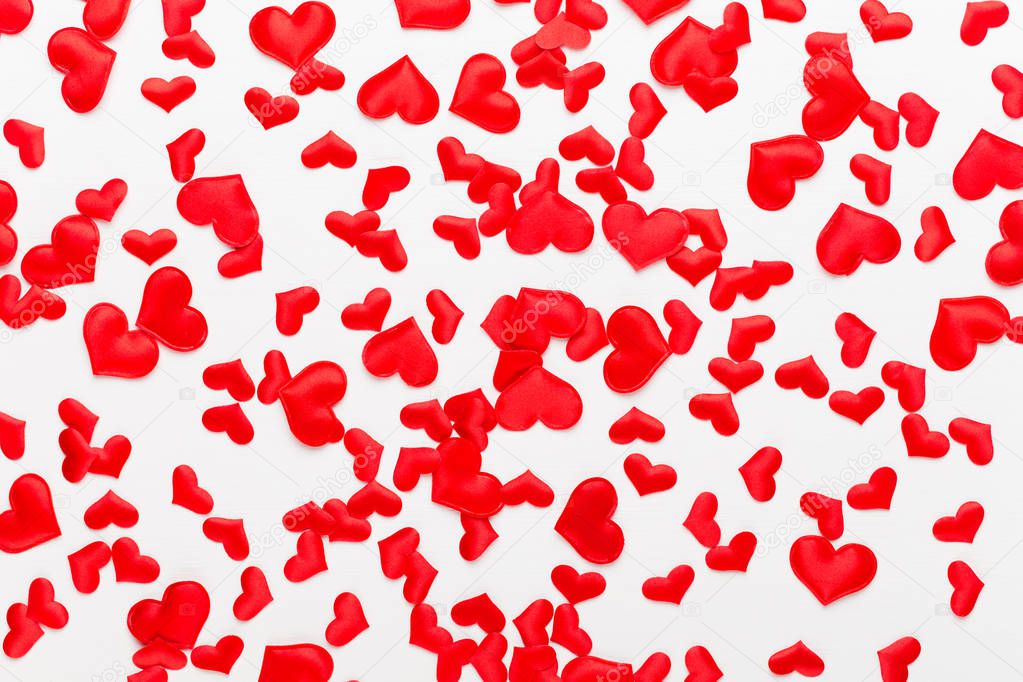 Valentines day background red hearts on white wooden background.