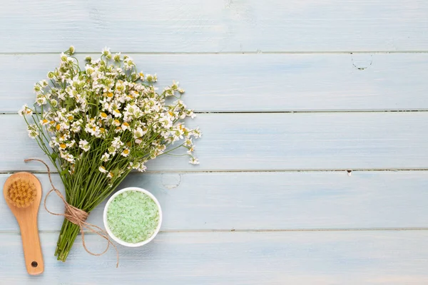 Sea salt, aromatherapy oil in bottles and chamomile on vintage w — Stock Photo, Image