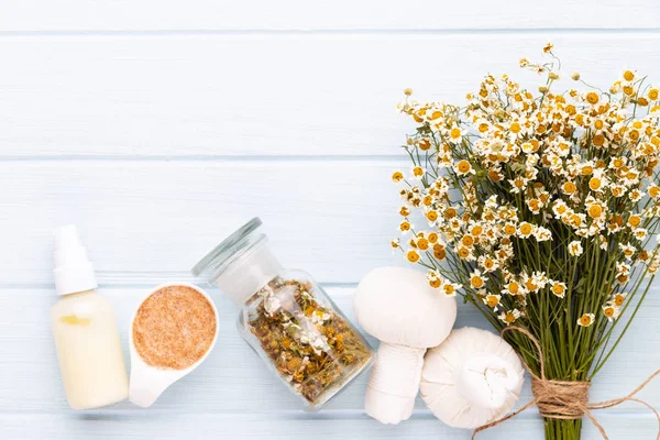 Sea salt, aromatherapy oil in bottles and chamomile on vintage w — Stock Photo, Image