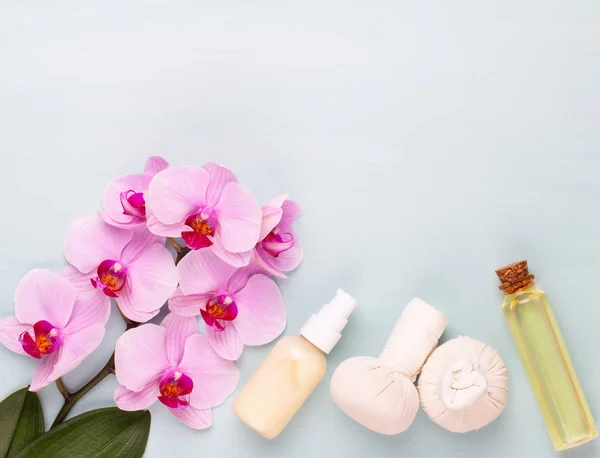 Sea salt, aromatherapy oil in bottles and orchid on vintage wood — Stock Photo, Image