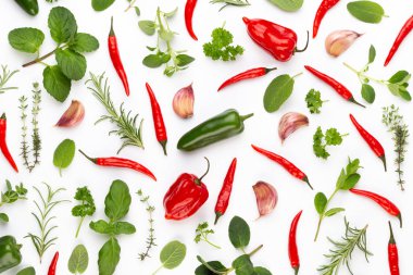 Baharatlı bitkisel yapraklar ve beyaz arka planda kırmızı biber. Vegeta