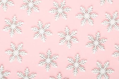 Noel arkaplanı. Beyaz kar süslemeleri pembe bir sırtüstü