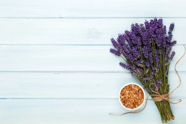 Grooming products and fresh lavender bouquet on white wooden tab
