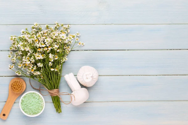 Sea salt, aromatherapy oil in bottles and chamomile on vintage w — Stock Photo, Image