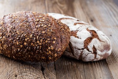 Ahşap arka planda altın kırsal ekmek ve çörekler