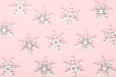 Noel arkaplanı. Beyaz kar süslemeleri pembe bir sırtüstü