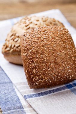 Ahşap arka planda altın kırsal ekmek ve çörekler